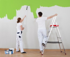 Young Couple Painting Wall